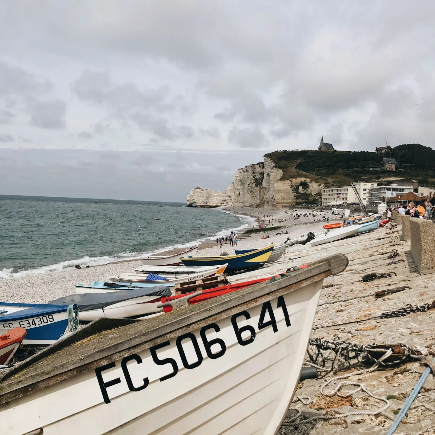 white and red boat on beach during daytime